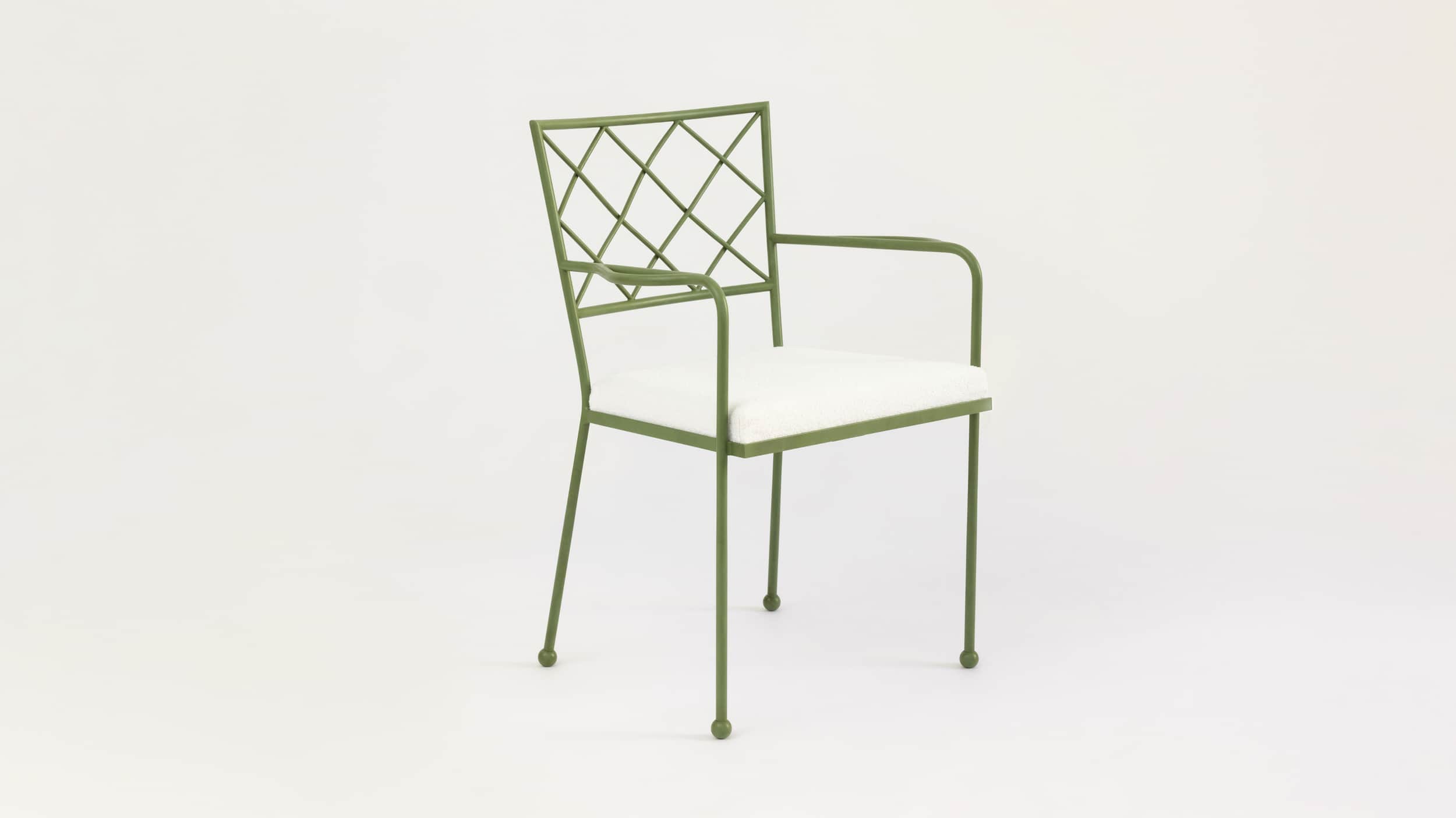 A green metal armchair with a white upholstered seat and a diamond-patterned backrest. The armchair… — 3D model