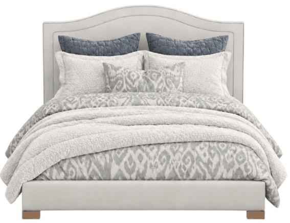 An upholstered bed featuring a subtly scalloped headboard, a low-profile frame, and a neutral color palette. The bed is adorned with coordinated bedding in shades of white, grey, and blue. — 3D model