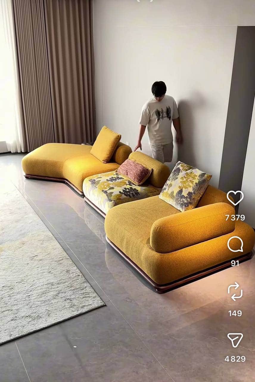 A multi-piece modular sectional sofa with curvilinear forms, upholstered in a mustard yellow fabric,… — 3D model