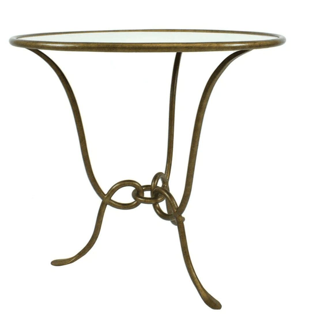 A small, round-topped accent table with a metallic base. The base consists of three curved legs that… — 3D model