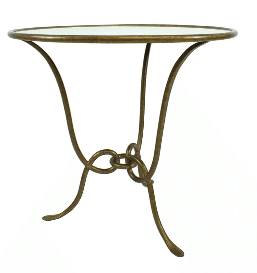 A small, round-topped accent table with a metallic base. The base consists of three curved legs that meet and intertwine in the center with a knot-like design. The tabletop appears to be a flat, possibly mirrored or lacquered surface, with a thin, metallic rim. — 3D model