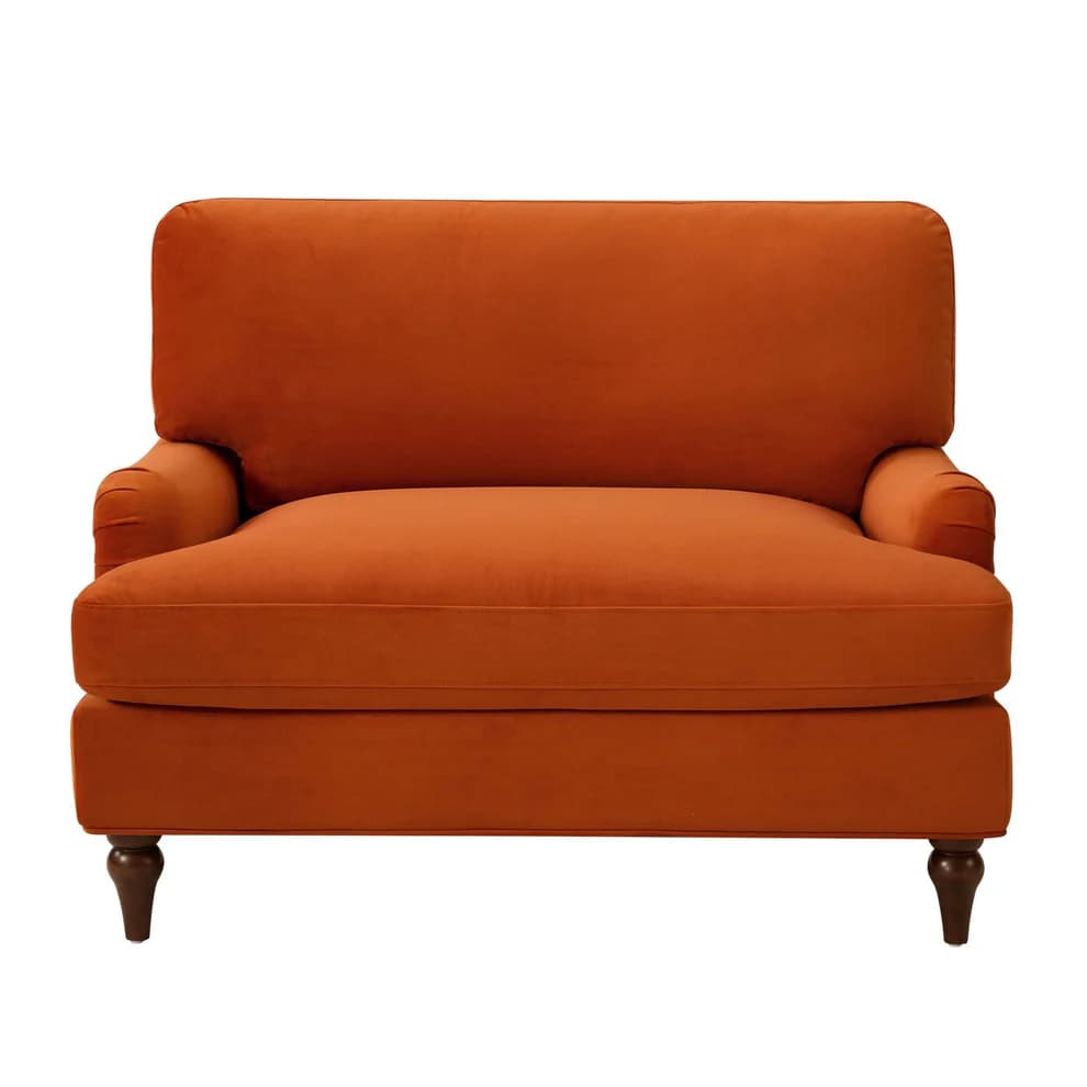 A plush, deep-seated armchair upholstered in a vibrant rust orange velvet fabric. It features rolled arms, a T-cushion backrest, and a single seat cushion. The chair is supported by four dark, turned wooden legs. — 3D model