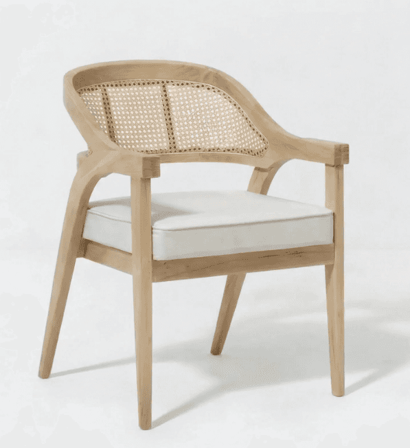 A light-toned wooden armchair featuring a curved cane backrest and a removable off-white upholstered… — 3D model
