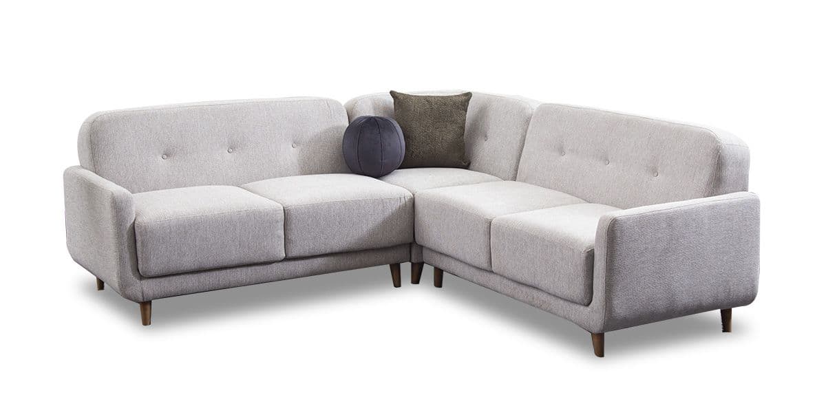 A light gray upholstered sectional sofa with button tufting on the backrests. It features a modern design with rounded arms and tapered wooden legs. The sofa includes two accent pillows: one round dark gray pillow and one rectangular dark brown textured pillow. The upholstery appears to be a textured fabric. — 3D model