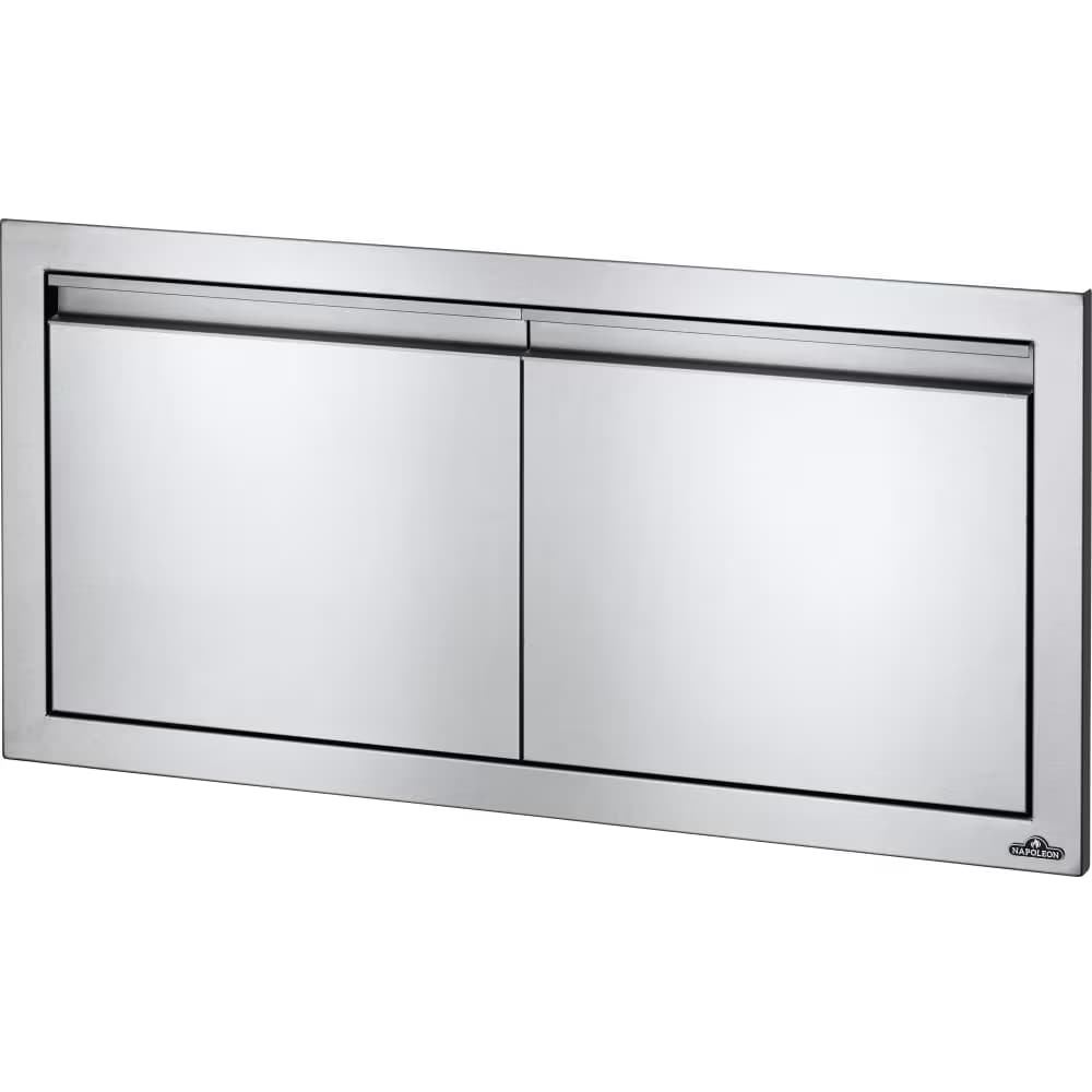 A polished stainless steel built-in outdoor kitchen storage cabinet featuring two horizontal hinged doors, each with an integrated bar pull handle. It has a flush-mount frame designed for seamless integration into an outdoor kitchen island. A brand logo is present on the lower right door. — 3D model
