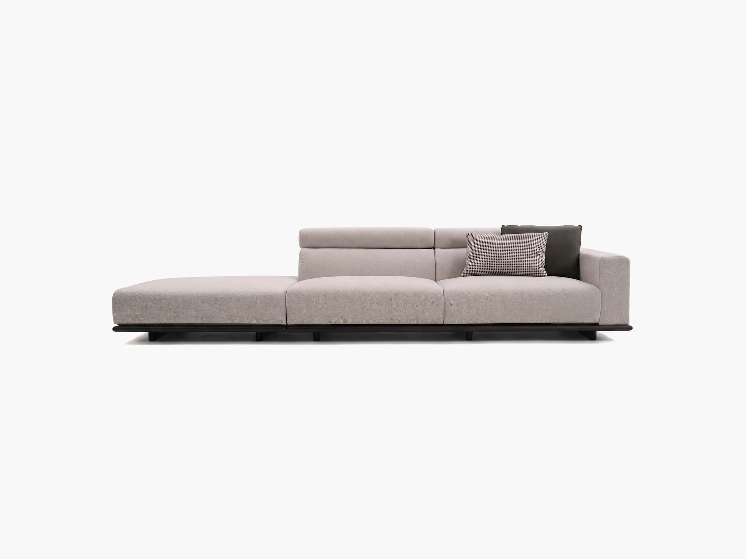 A modern modular sofa featuring a chaise lounge component on the left, upholstered in a light grey t… — 3D model