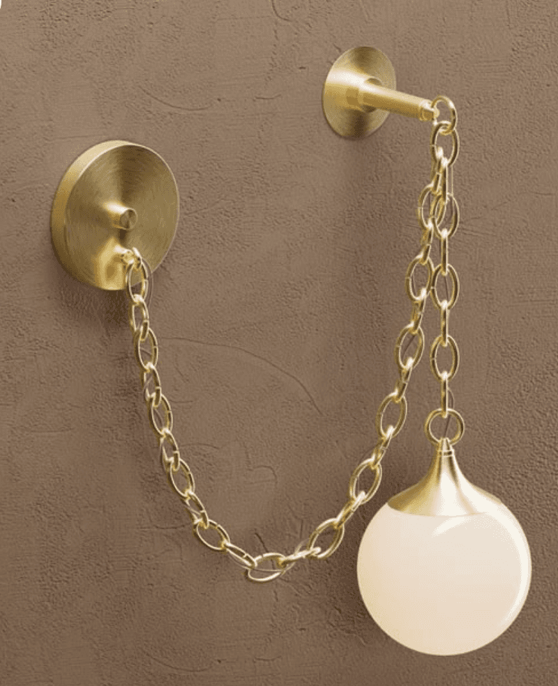 A modern wall-mounted light fixture, characterized by its brass construction and a frosted spherical… — 3D model
