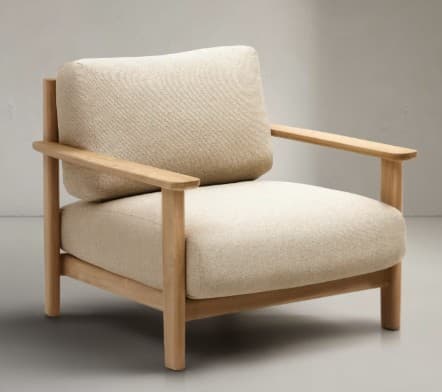 A modern armchair featuring a minimalist design with a natural wood frame and upholstered cushions. The frame consists of squared legs and armrests. The seat and back cushions are plump and covered in a textured, light-colored fabric. — 3D model