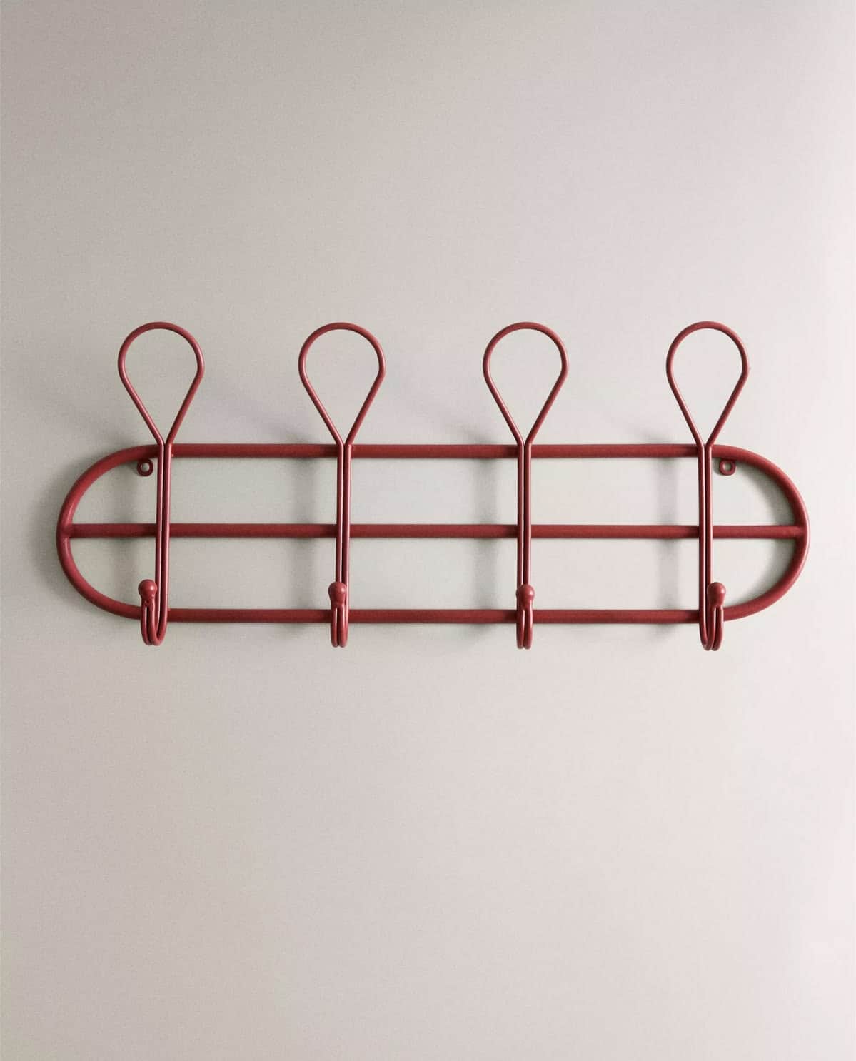 A wall-mounted coat rack featuring an oval frame with an internal horizontal bar supporting four hoo… — 3D model