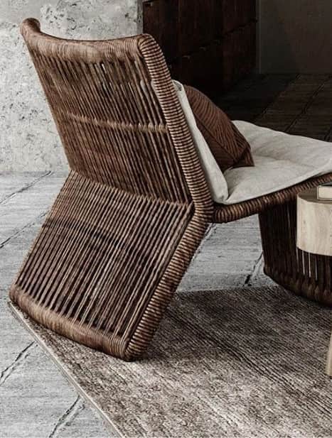 A modern lounge chair constructed from a woven material, featuring a sloping seat and back. It inclu… — 3D model