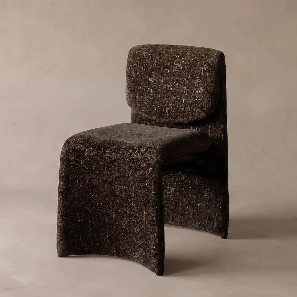 An armless chair featuring a unique, continuous sculptural form, fully upholstered in a dark brown,… — 3D model