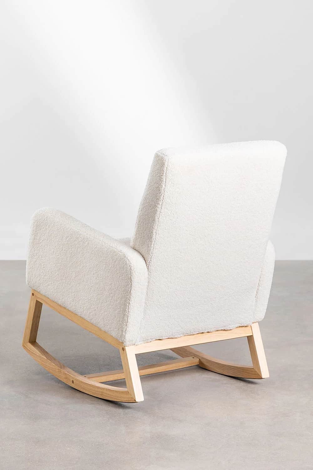 A rocking chair with a plush, textured upholstery and a natural wood frame. The chair features a hig… — 3D model