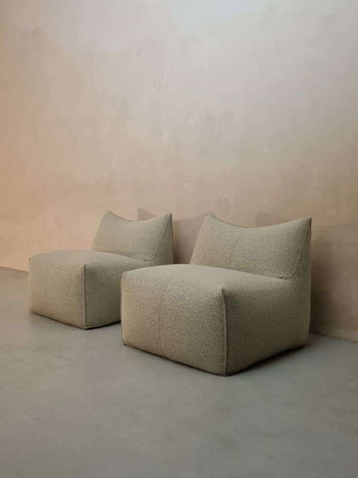 An armless, upholstered lounge chair with a low profile and a subtly curved backrest, covered in tex… — 3D model
