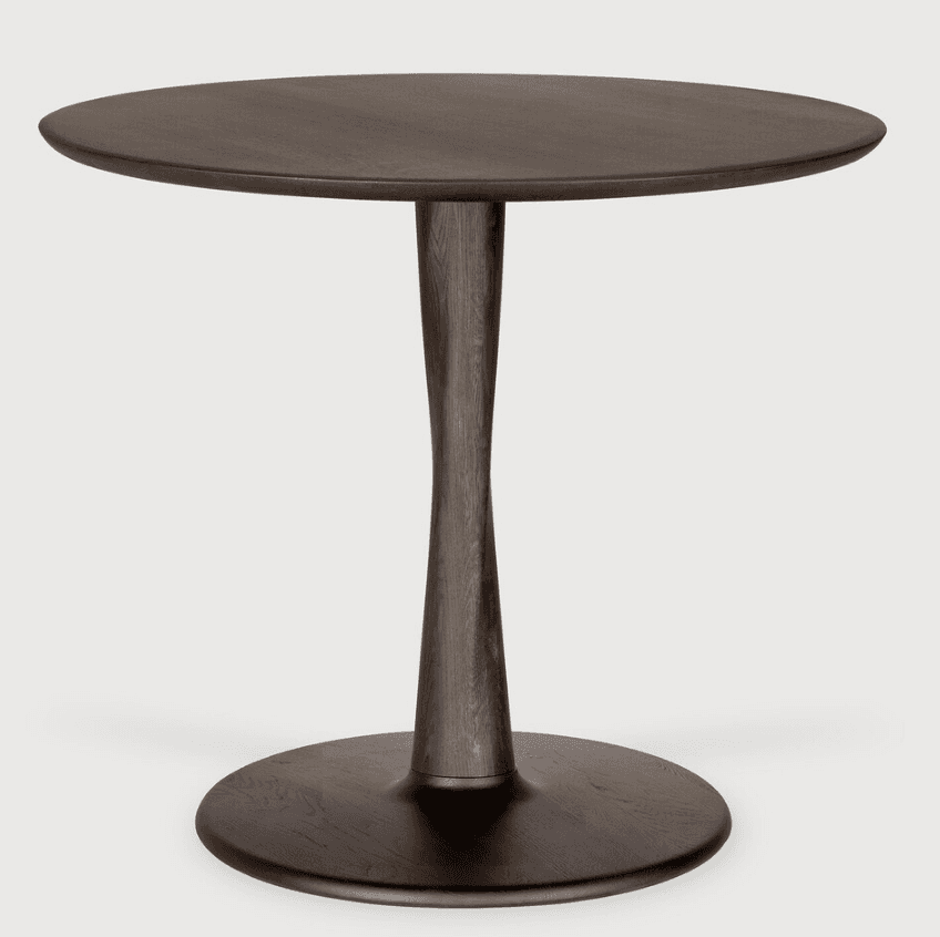 A round table with a dark wood finish, featuring a distinctive hourglass-shaped pedestal base and a… — 3D model