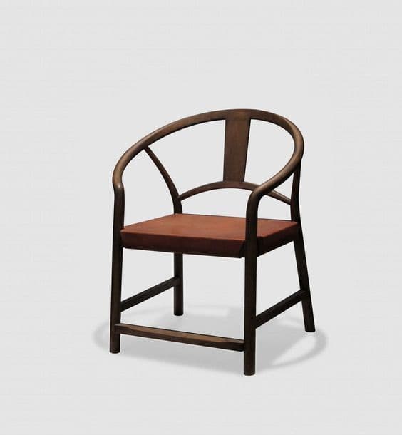 A dark wood armchair featuring a distinctive continuous, horseshoe-shaped backrest and armrests, paired with a flat, padded reddish-brown leather seat. The chair's frame is made of solid wood, exhibiting clean lines and a minimalist aesthetic. — 3D model