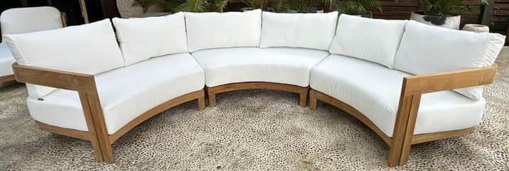 A modular outdoor sectional sofa with a curved design, featuring a wooden frame and white upholstere… — 3D model