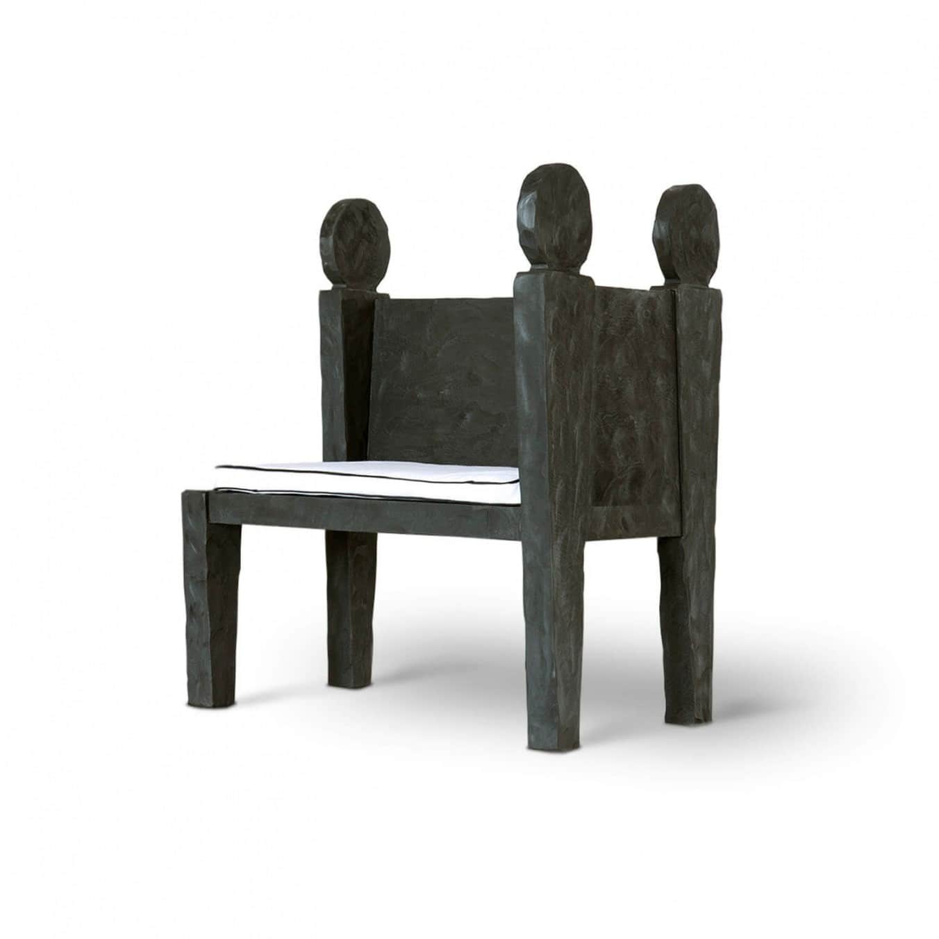 A high-backed armchair characterized by its robust, block-like construction and dark, roughly textur… — 3D model
