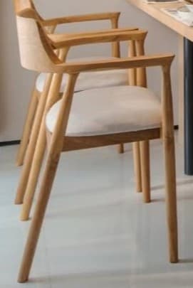 A modern armchair crafted from light-toned wood with a curved backrest and integrated armrests, featuring a comfortable upholstered seat in a neutral fabric. — 3D model