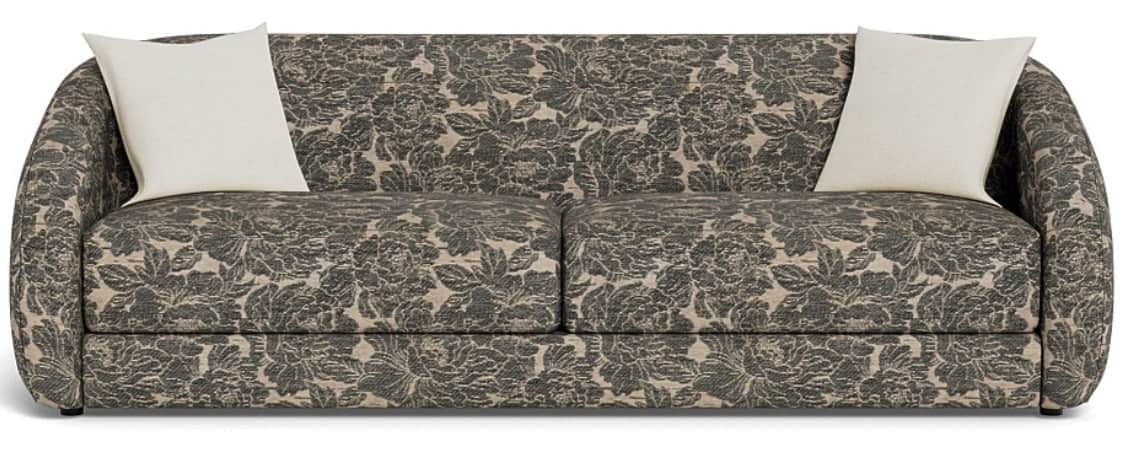 A contemporary sofa fully upholstered in a dark beige and grey botanical pattern fabric. It features… — 3D model