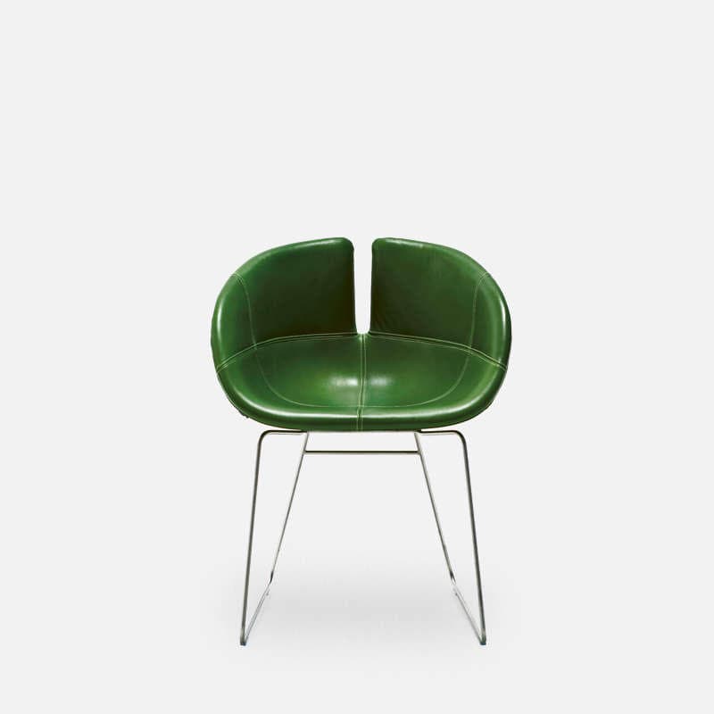 A modern chair featuring a vibrant green upholstered seat and backrest with a distinctive split in the upper back. The single-piece shell-like form is supported by a sleek, polished metal sled base. — 3D model
