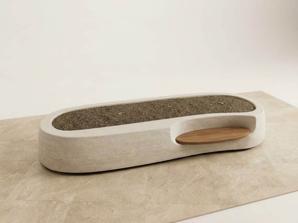 An elongated, oval-shaped planter bench made from light-colored concrete or a similar composite mate… — 3D model
