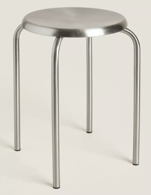 A simple, round-seated stool with four curved metal legs, featuring a minimalist and industrial design. — 3D model