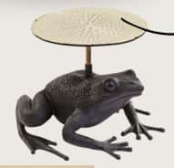 A whimsical accent table featuring a dark bronze-finished frog as its base, supporting a textured, r… — 3D model