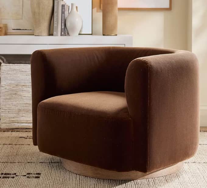 An elegant contemporary swivel barrel chair featuring a dark brown fabric upholstery and a round, li… — 3D model