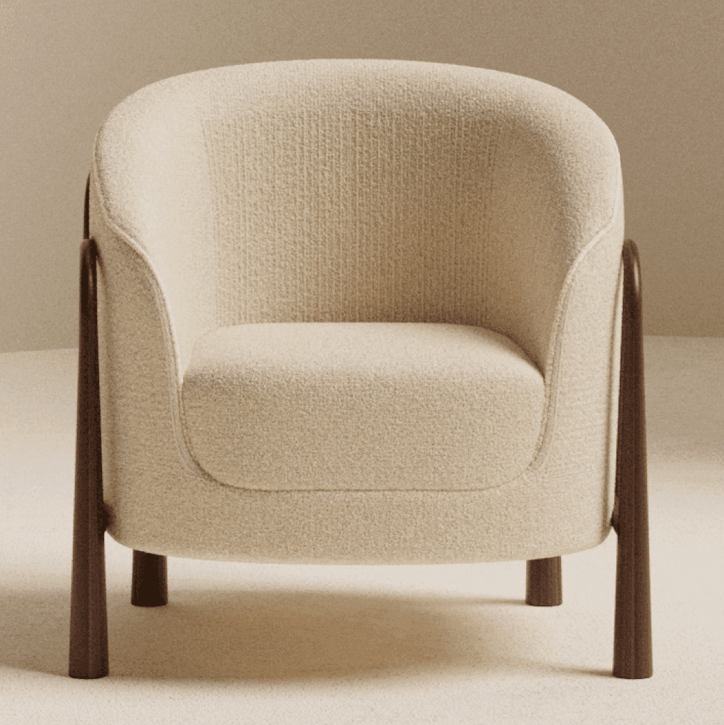 A contemporary accent armchair featuring a rounded, upholstered body covered in a cream-colored, textured boucle-like fabric. The chair has exposed dark wood elements that form the armrests and extend downwards to become the tapered legs. The design emphasizes soft curves and a minimalist aesthetic. — 3D model