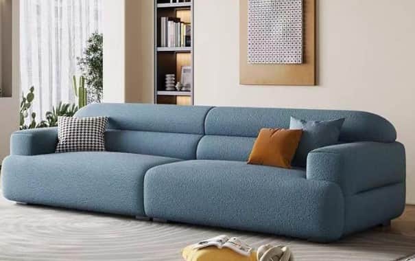 A modular sectional sofa with a light blue textured fabric upholstery. The sofa features rounded arm… — 3D model