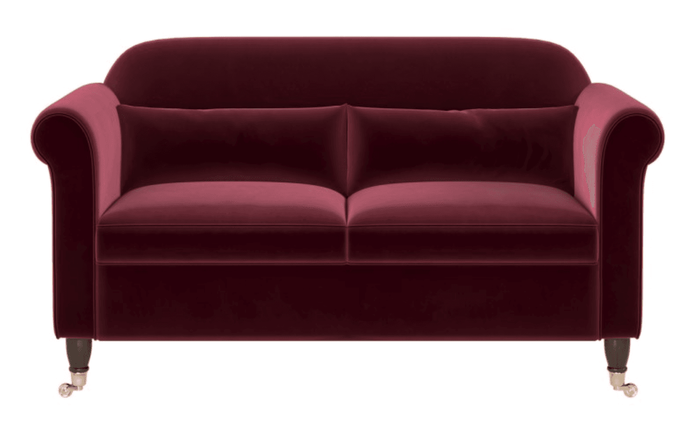 A traditional two-seater loveseat upholstered in deep burgundy velvet. It features classic rolled arms, two loose seat cushions, and two loose back cushions. The frame rests on short, dark wooden legs, with the front legs terminating in brass caster wheels for mobility. The overall design suggests a classic or Victorian-inspired aesthetic. — 3D model