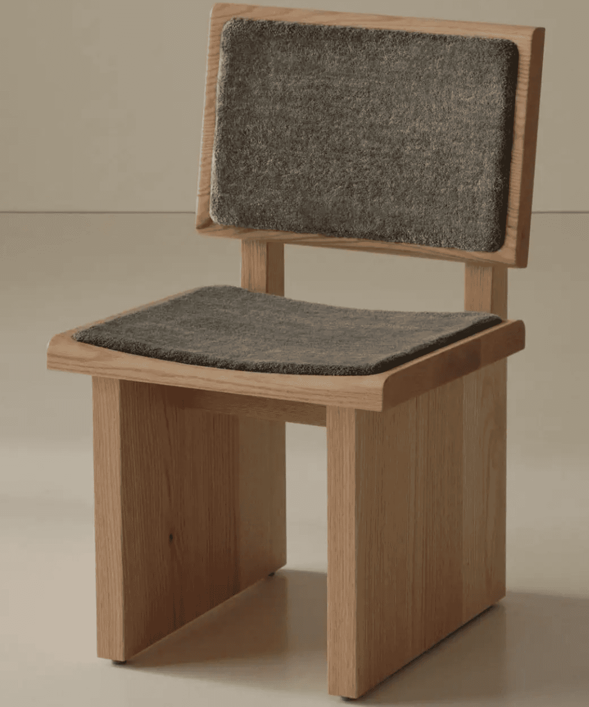 A modern wooden chair with a minimalist design. It features a seat and backrest upholstered in a dar… — free GLTF 3D model