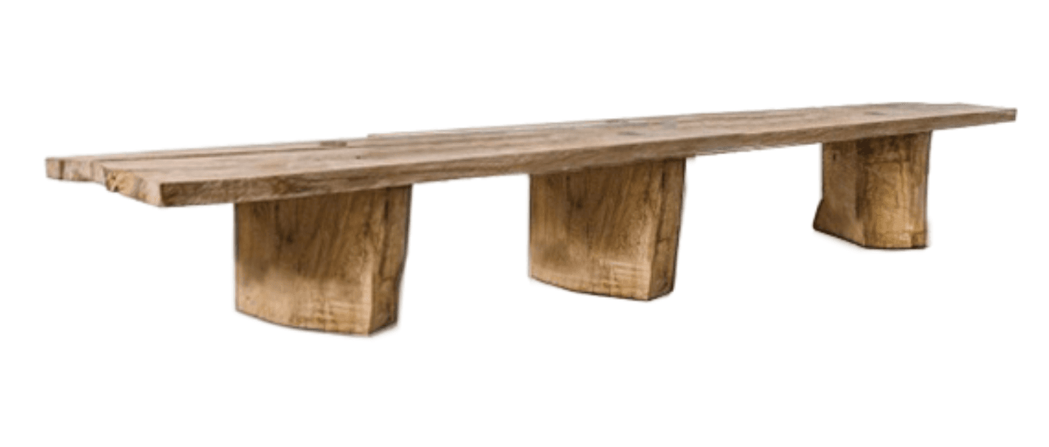 A long, rustic wooden bench crafted from what appears to be reclaimed or heavily textured wood. The top is composed of multiple thick planks, and it is supported by three substantial block-like legs that have a natural, organic shape, wider at the top and slightly curved or rounded towards the base. The wood has a light, weathered appearance. — 3D model