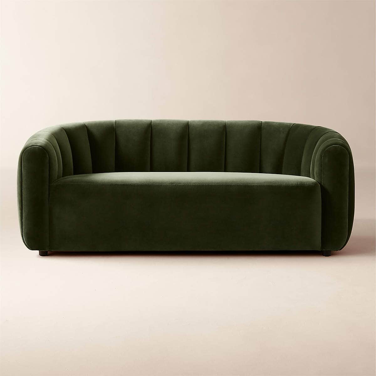 A modern sofa upholstered in deep olive green velvet, featuring a continuous, channel-tufted backres… — 3D model