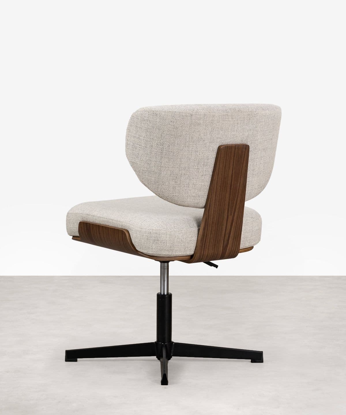 An upholstered swivel chair featuring a distinct curved bentwood shell that forms the lower back and seat structure, contrasted with a light-colored fabric upholstery for comfort. The chair rests on a matte black four-star swivel base. — 3D model