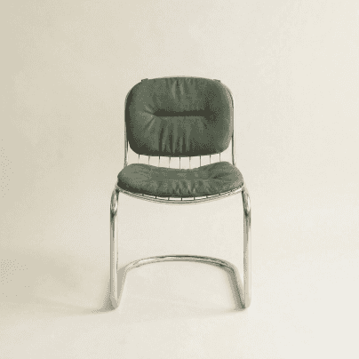 A modernist side chair featuring a polished chrome cantilever frame and separate, dark green upholst… — 3D model