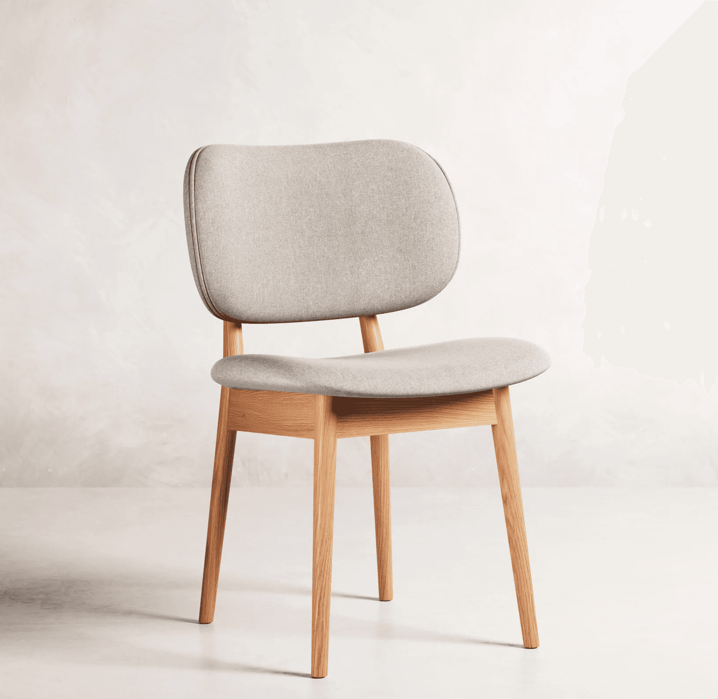A modern Scandinavian dining chair featuring a light wood frame and light grey upholstered seat and backrest. The chair has clean lines with subtly splayed, tapered legs. Both the seat and the backrest are softly rounded and padded, offering a comfortable and minimalist design. — 3D model