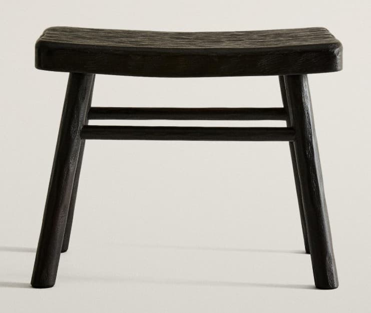A dark, textured wooden stool featuring a subtly curved saddle seat and four splayed, tapered legs reinforced by two horizontal stretchers on each side. — 3D model