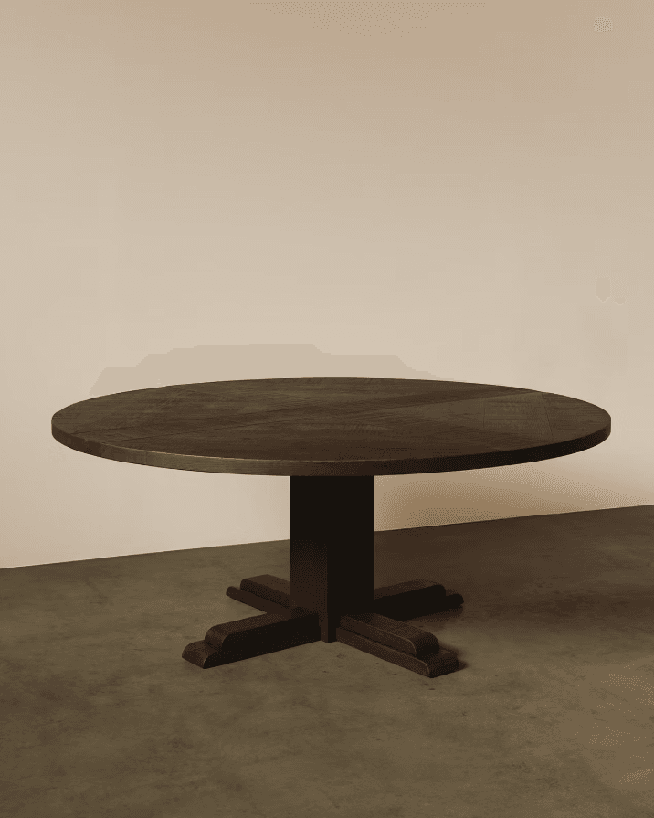 A round dining table crafted from dark stained wood, featuring a chevron pattern on its tabletop and supported by a central pedestal base with a cross-shaped foot. — 3D model