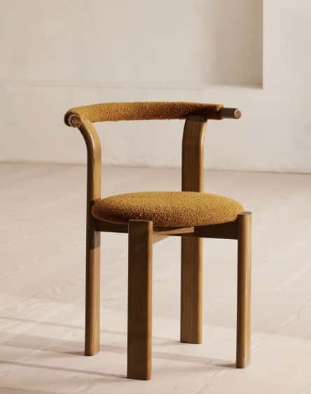 A modern armchair featuring a curved wooden frame with an upholstered backrest and seat. The frame i… — free BLEND 3D model