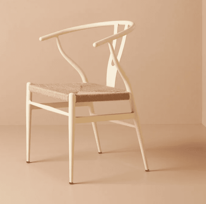 An off-white or cream-colored wooden chair with a distinctive Y-shaped backrest and integrated armre… — 3D model