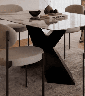 A rectangular dining table featuring a grey and white marble-patterned top with gently rounded corners, supported by a distinctive matte black geometric pedestal base composed of intersecting angled planes. — 3D model
