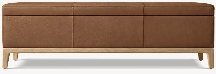 A rectangular, modern upholstered bench featuring a rich brown, grainy leather upholstery with precise stitched paneling on the top surface. It is supported by a light-colored wooden base with subtly splayed and tapered legs. — 3D model