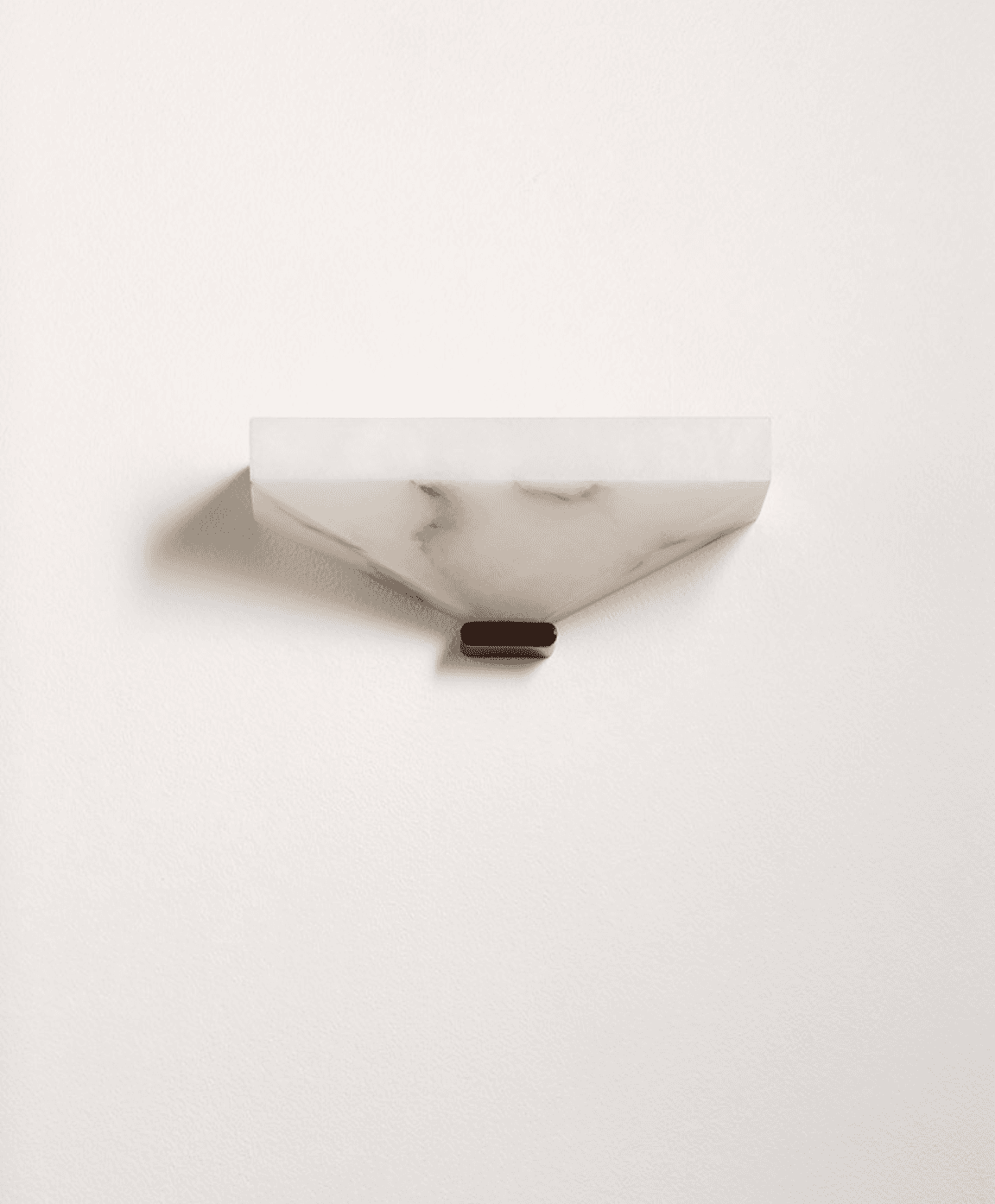 A contemporary wall sconce crafted from translucent alabaster, featuring a faceted, geometric form. The body is an inverted, truncated pyramid shape with a flat top, designed to cast light primarily upwards or downwards, depending on orientation. It exhibits natural veining inherent to alabaster, contributing to its organic yet refined aesthetic. A small, dark, rectangular base element is visible at the bottom, likely serving as a mounting point or decorative accent. The overall design suggests a sophisticated and minimalist lighting solution. — 3D model