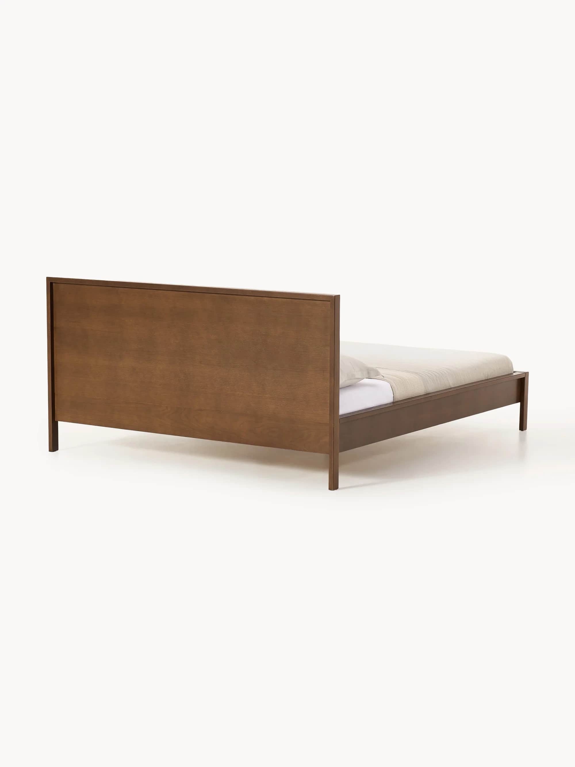 A modern platform bed featuring a clean, minimalist design crafted from dark-stained wood. It includ… — 3D model