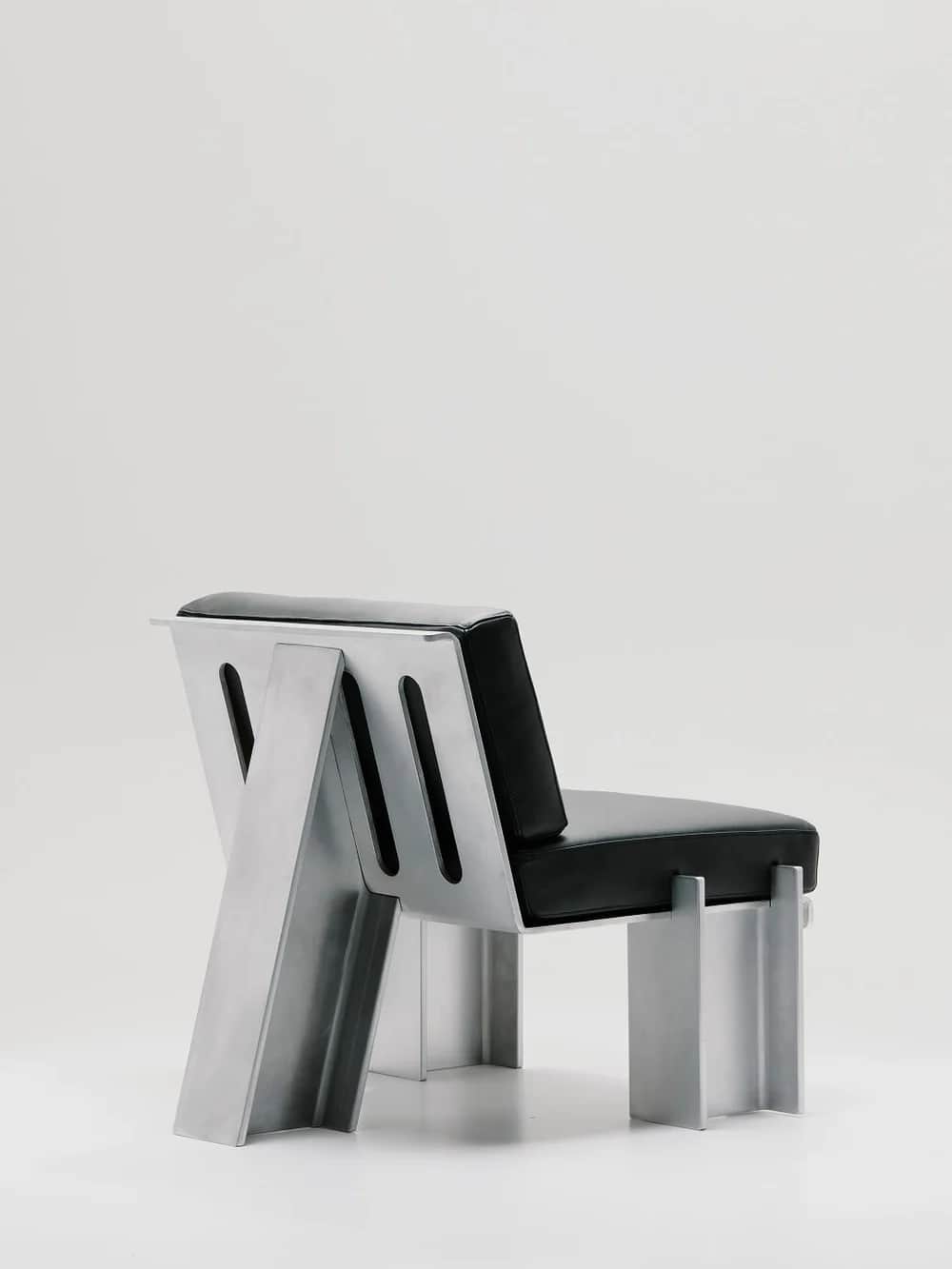 An industrial-style armchair featuring a robust, angular frame constructed from heavy-gauge aluminum… — 3D model