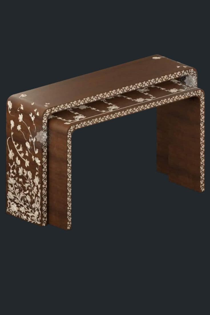 A set of two nesting tables featuring a dark brown wood finish adorned with intricate floral and vine-like mother-of-pearl inlay. The tables are of a waterfall design, where the top surface seamlessly curves down to form the legs, creating a continuous U-shape. The smaller table is designed to slide completely underneath the larger one for space-saving storage. The inlay pattern is consistent across both tables, detailing the top and side surfaces with delicate botanical motifs. — 3D model