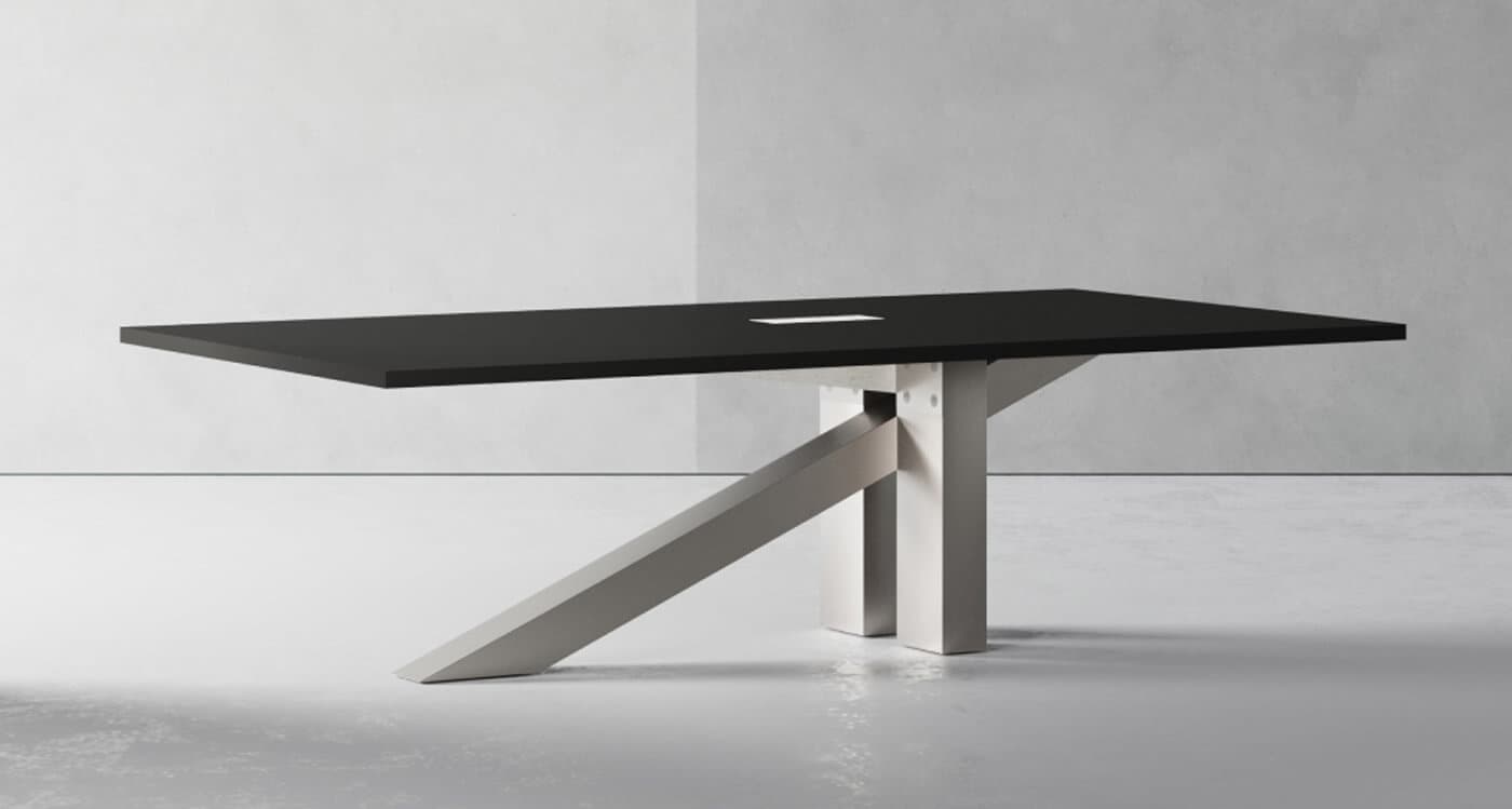 A long, rectangular table featuring a dark, matte black tabletop and a distinctive light-colored geometric base. The base consists of a central T-shaped support structure with an additional angled support extending from it. A small, rectangular cutout is visible on the tabletop, suggesting integrated power or data access. The overall design is sleek and contemporary. — 3D model