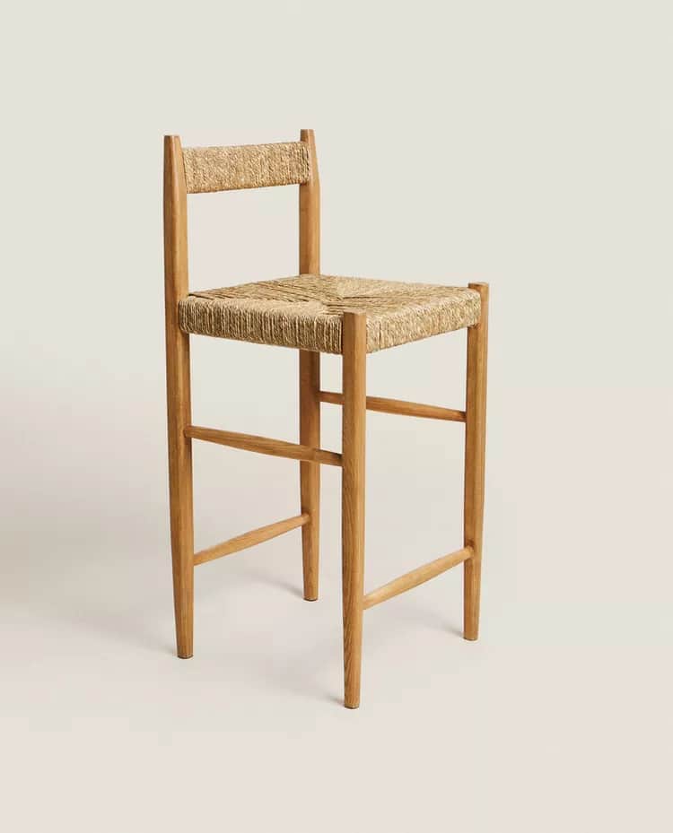 A tall bar stool constructed with a wooden frame and a woven natural fiber seat and backrest. The st… — 3D model