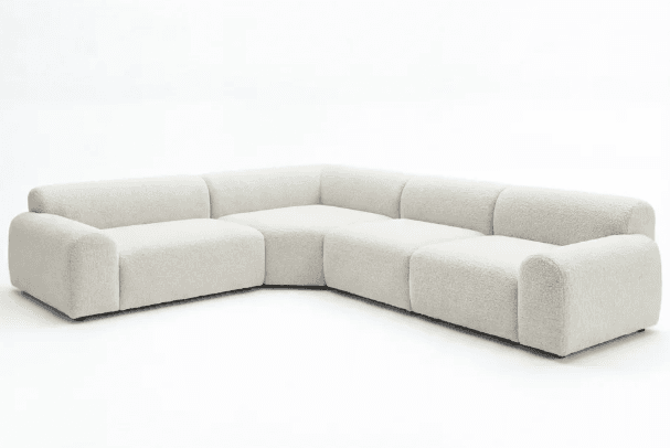 An L-shaped modular sectional sofa upholstered in a light, textured bouclé fabric, featuring rounded edges and a low-profile design, against a plain white background. — 3D model